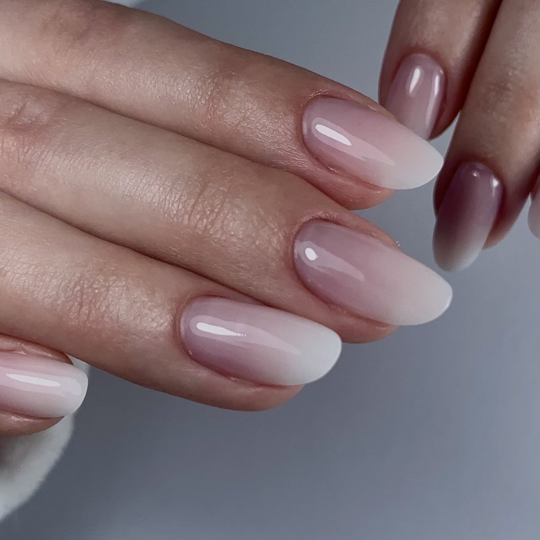 Nails after: fresh gel retouch with a natural soft pink-to-white ombré, almond shape, by Marina in Merode, Brussels